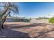 Spacious backyard with a refreshing pool, surrounded by charming stone and metal fencing, with small decorative stone ground cover at 325 E Harmony Ave, Mesa, AZ 85210