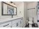 Updated bathroom featuring a vanity with a light countertop and dark hardware at 325 E Harmony Ave, Mesa, AZ 85210