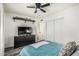 Comfortable bedroom featuring a large closet, modern TV console, and decor shelving at 325 E Harmony Ave, Mesa, AZ 85210