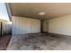 Covered carport with storage room featuring white brick walls and ample space for parking at 325 E Harmony Ave, Mesa, AZ 85210