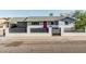 Charming single-story home with gray exterior, red door, and white brick and black horizontal slat fence at 325 E Harmony Ave, Mesa, AZ 85210