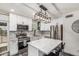 Spacious kitchen featuring an island, stainless steel appliances, white cabinetry, and stylish pendant lighting at 325 E Harmony Ave, Mesa, AZ 85210
