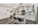 Bright kitchen with an island, stainless steel appliances, white cabinets, a view to the pool and a dining table at 325 E Harmony Ave, Mesa, AZ 85210
