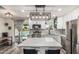 Bright kitchen with white cabinets, stainless steel appliances, pendant lighting, and a view of the pool from the sliding glass door at 325 E Harmony Ave, Mesa, AZ 85210