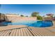 Inviting backyard swimming pool featuring clear blue water, stone perimeter wall, and concrete surroundings on a sunny day at 325 E Harmony Ave, Mesa, AZ 85210
