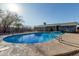 Backyard pool with clear blue water, secure fencing, and a patio area perfect for outdoor relaxation and enjoyment at 325 E Harmony Ave, Mesa, AZ 85210