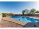 Inviting backyard pool featuring a decorative butterfly, clear blue water, concrete trim, and surrounded by gravel ground cover at 325 E Harmony Ave, Mesa, AZ 85210