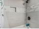 Nicely tiled shower with a built-in niche for convenient storage at 325 E Harmony Ave, Mesa, AZ 85210
