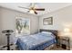 Bright bedroom featuring a ceiling fan, plush bedding, and a large window with great views at 3505 S Westfall Ave, Tempe, AZ 85282