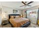 Comfortable main bedroom featuring a ceiling fan, plush bedding, and lots of natural light at 3505 S Westfall Ave, Tempe, AZ 85282