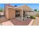 Backyard featuring a covered patio with chairs, a brick border, and a sliding door entry into the home at 3510 E Hampton Ave # 18, Mesa, AZ 85204