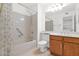 Full bathroom with vanity, bathtub, shower, and toilet, featuring tile floors and oak cabinets at 3510 E Hampton Ave # 18, Mesa, AZ 85204