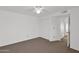 Bedroom with neutral carpet, white walls, a ceiling fan and access to a closet and bathroom at 3510 E Hampton Ave # 18, Mesa, AZ 85204