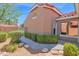Exterior view of the home with manicured landscaping, including green bushes and decorative rock at 3510 E Hampton Ave # 18, Mesa, AZ 85204