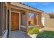 Inviting front entryway featuring a decorative wood door, and ample natural light from the adjacent window at 3510 E Hampton Ave # 18, Mesa, AZ 85204