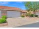 Welcoming home featuring a two-car garage and well-maintained landscaping under a clear, blue sky at 3510 E Hampton Ave # 18, Mesa, AZ 85204