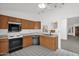 Functional kitchen with oak cabinetry, tiled floors, and a view into the dining room at 3510 E Hampton Ave # 18, Mesa, AZ 85204