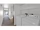 Functional laundry room with a washer, dryer, and upper shelving for storage at 3510 E Hampton Ave # 18, Mesa, AZ 85204