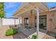 Inviting covered patio with leafy rug, table and chairs, and views to the backyard at 3510 E Hampton Ave # 18, Mesa, AZ 85204