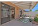 Patio area featuring a dining table, plants, sliding glass door and an overhead awning at 3510 E Hampton Ave # 18, Mesa, AZ 85204
