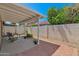 Covered patio area featuring chairs, greenery, a block fence and a lush citrus tree overhead at 3510 E Hampton Ave # 18, Mesa, AZ 85204