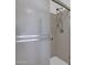 Close up of a shower stall featuring a handheld shower head, glass door, and chrome fixtures at 3510 E Hampton Ave # 18, Mesa, AZ 85204