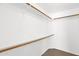 Walk-in closet with wooden rods and shelves to maximize storage and help keep you organized at 3510 E Hampton Ave # 18, Mesa, AZ 85204