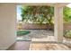 Inviting backyard with decorative rock, small grassy area, large shade tree and covered patio at 3534 E Linda Ln, Gilbert, AZ 85234