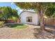 The home's backyard features desert landscaping, a shade tree, and a small, well kept lawn at 3534 E Linda Ln, Gilbert, AZ 85234