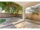Backyard featuring a covered patio, gravel, a brick wall, and a mature tree at 3534 E Linda Ln, Gilbert, AZ 85234