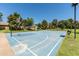 Community basketball court with bleachers surrounded by mature trees at 3534 E Linda Ln, Gilbert, AZ 85234