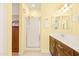 Bright bathroom featuring a walk-in shower, vanity with a long countertop, and neutral tile floors at 3534 E Linda Ln, Gilbert, AZ 85234