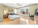 Cozy bedroom with wood floors, a large window, and a dedicated workspace for comfortable living and productivity at 3534 E Linda Ln, Gilbert, AZ 85234