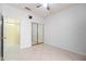 Bedroom with white walls, tile flooring, a closet with sliding doors, and a ceiling fan at 3534 E Linda Ln, Gilbert, AZ 85234