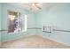 Light-filled bedroom with pale blue walls, tile floors, a ceiling fan, and a built-in shelf at 3534 E Linda Ln, Gilbert, AZ 85234