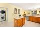 Bright kitchen space with a convenient island, modern appliances, and adjacent laundry area for added functionality at 3534 E Linda Ln, Gilbert, AZ 85234