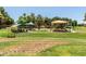 Community playground with shaded picnic tables, play equipment and a grassy lawn at 3534 E Linda Ln, Gilbert, AZ 85234
