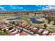 Expansive aerial view of a neighborhood with a golf course, water features, and vibrant community amenities at 4225 E Sandia St, Phoenix, AZ 85044
