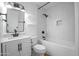 This modern bathroom features a tub/shower combo, and a white vanity at 4225 E Sandia St, Phoenix, AZ 85044