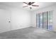 This bright bedroom has a ceiling fan, and sliding glass doors to the outside at 4225 E Sandia St, Phoenix, AZ 85044