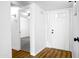 Bright foyer with a front door and open doorway to a living space with fan and hardwood flooring at 4225 E Sandia St, Phoenix, AZ 85044