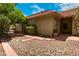 Side view of home with brick paver and rock landscaping leading to tan stucco exterior and trimmed shrubbery at 4225 E Sandia St, Phoenix, AZ 85044