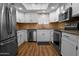 A renovated kitchen featuring stainless steel appliances, white cabinets, and granite countertops at 4225 E Sandia St, Phoenix, AZ 85044