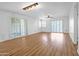 Open living room with hardwood floors, recessed lighting and sliding glass doors with wood shutters at 4225 E Sandia St, Phoenix, AZ 85044