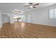 Open living room to kitchen with hardwood floors, recessed lighting and sliding glass doors with wood shutters at 4225 E Sandia St, Phoenix, AZ 85044