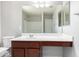 Bathroom vanity with brown cabinets and a white countertop featuring a large mirror at 5113 E Greenway E St, Mesa, AZ 85205