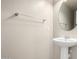 Neutral powder room with a pedestal sink, decorative mirror, and textured walls at 5113 E Greenway E St, Mesa, AZ 85205