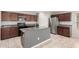 Well-equipped kitchen with granite countertops, stainless steel appliances, and rich, dark wood cabinets at 5113 E Greenway E St, Mesa, AZ 85205