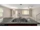 Modern kitchen with a large island, stainless steel sink, and an open view to the living area at 5113 E Greenway E St, Mesa, AZ 85205
