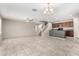 Bright, open-concept living space with tile floors, ceiling fan, and staircase access to the second floor at 5113 E Greenway E St, Mesa, AZ 85205